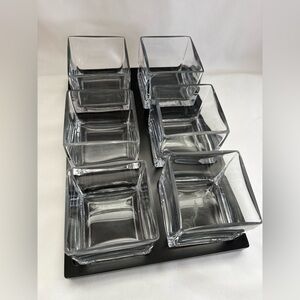 Set a six serving glasses in a recessed, black serving tray or mini herb garden